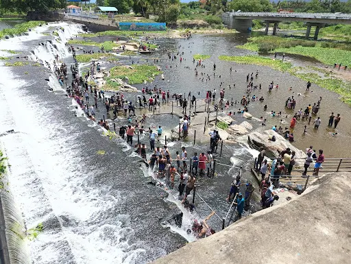Travelers bathed in pouring water as a robe at the flagvary dam near gobichettipalayam